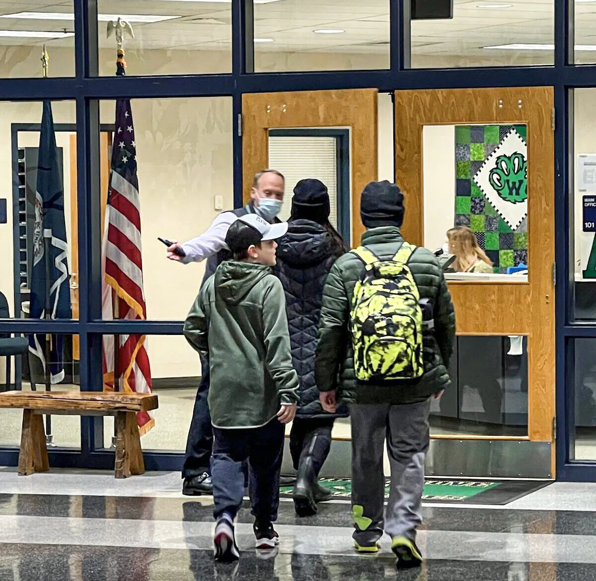 Principal William Shipp opens the door to direct unmasked students to the main office of Woodgrove High School in Purcellville, Va., on Feb. 2, 2022. (Courtesy of Erin Thomas)