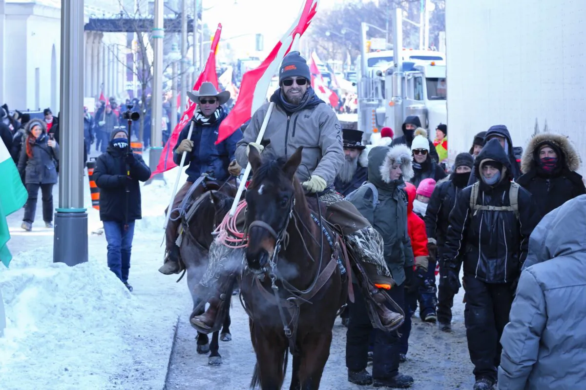 Protesters on horseback participate in the Truckers for Freedom demonstration against COVID-19 restrictions and mandates, on Parliament Hill in Ottawa on Feb. 5, 2022. (Jonathan Ren/The Epoch Times)