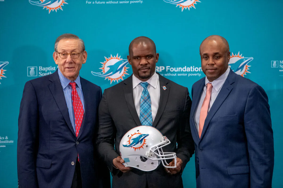 (L-R) Stephen Ross, chairman and owner, Brian Flores, head coach, and Chris Grier, general manager of the Miami Dolphins pose for the media after announcing Brian Flores as their new head coach at the Baptist Health Training Facility at Nova Southern University in Davie, Florida, on Feb. 4, 2019. (Mark Brown/Getty Images) 