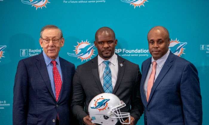(L-R) Stephen Ross, chairman and owner, Brian Flores, head coach, and Chris Grier, general manager of the Miami Dolphins pose for the media after announcing Brian Flores as their new head coach at the Baptist Health Training Facility at Nova Southern University in Davie, Florida, on Feb. 4, 2019. (Mark Brown/Getty Images) 