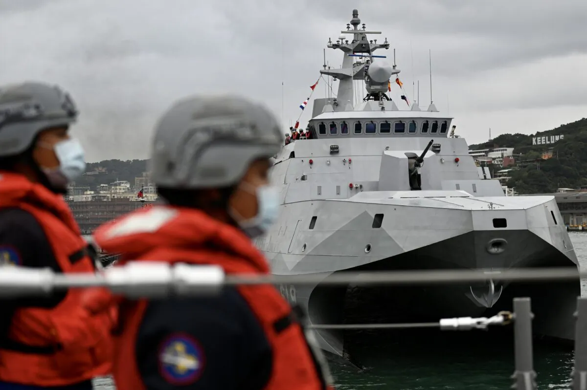Taiwan soldiers stand next to the domestically produced corvette class vessel Tuo Chiang (R) during a drill at the northern city of Keelung, Taiwan on Jan. 7, 2022. (SAM YEH/AFP via Getty Images)