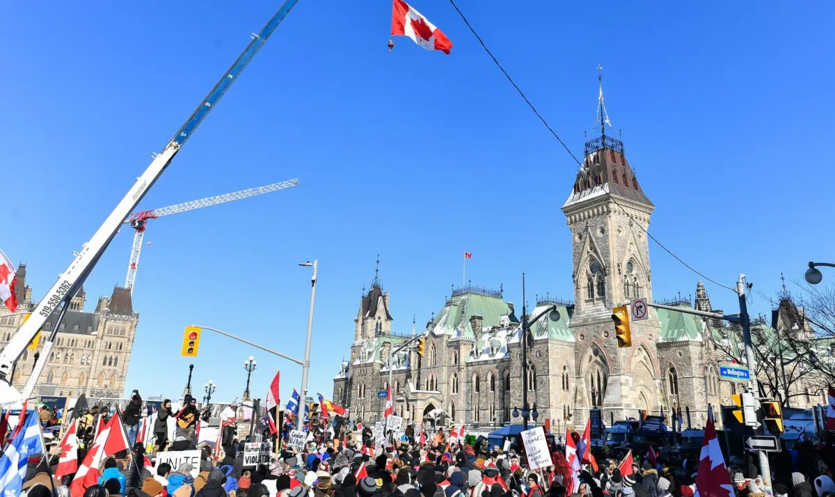 Thousands gather around Parliament Hill in support of the Freedom Convoy truckers' protest in Ottawa on Feb. 5, 2022. (Minas Panagiotakis/Getty Images)
