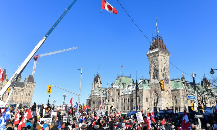 Thousands gather around Parliament Hill in support of the Freedom Convoy truckers' protest in Ottawa on Feb. 5, 2022. (Minas Panagiotakis/Getty Images)