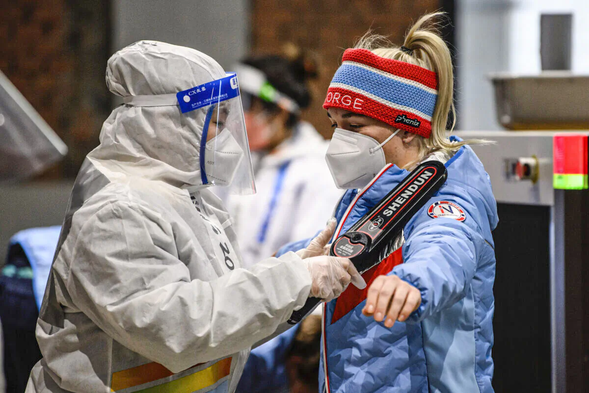 A member of Team Norway goes through security after arriving at the Olympic Village ahead of the Beijing 2022 Winter Olympic Games on Feb. 1, 2022. (Anthony Wallace - Pool/Getty Images)