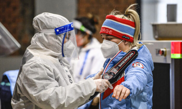 A member of Team Norway goes through security after arriving at the Olympic Village ahead of the Beijing 2022 Winter Olympic Games on Feb. 1, 2022. (Anthony Wallace - Pool/Getty Images)