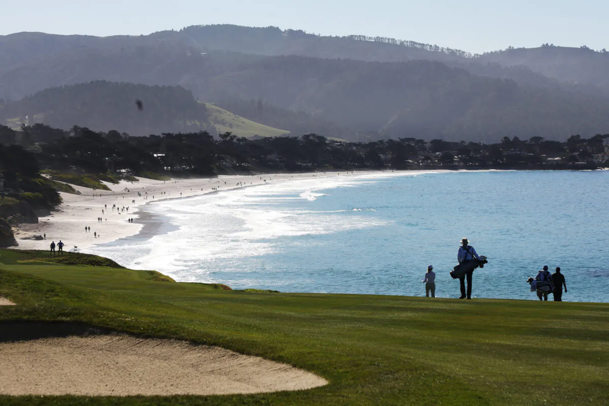 The group of Chris Kirk of the United States and Brian Stuard of the United States walk on the ninth hole during the second round of the AT&T Pebble Beach Pro-Am at Pebble Beach Golf Links, in Pebble Beach, Calif., on Feb. 4, 2022. (Jamie Squire/Getty Images)