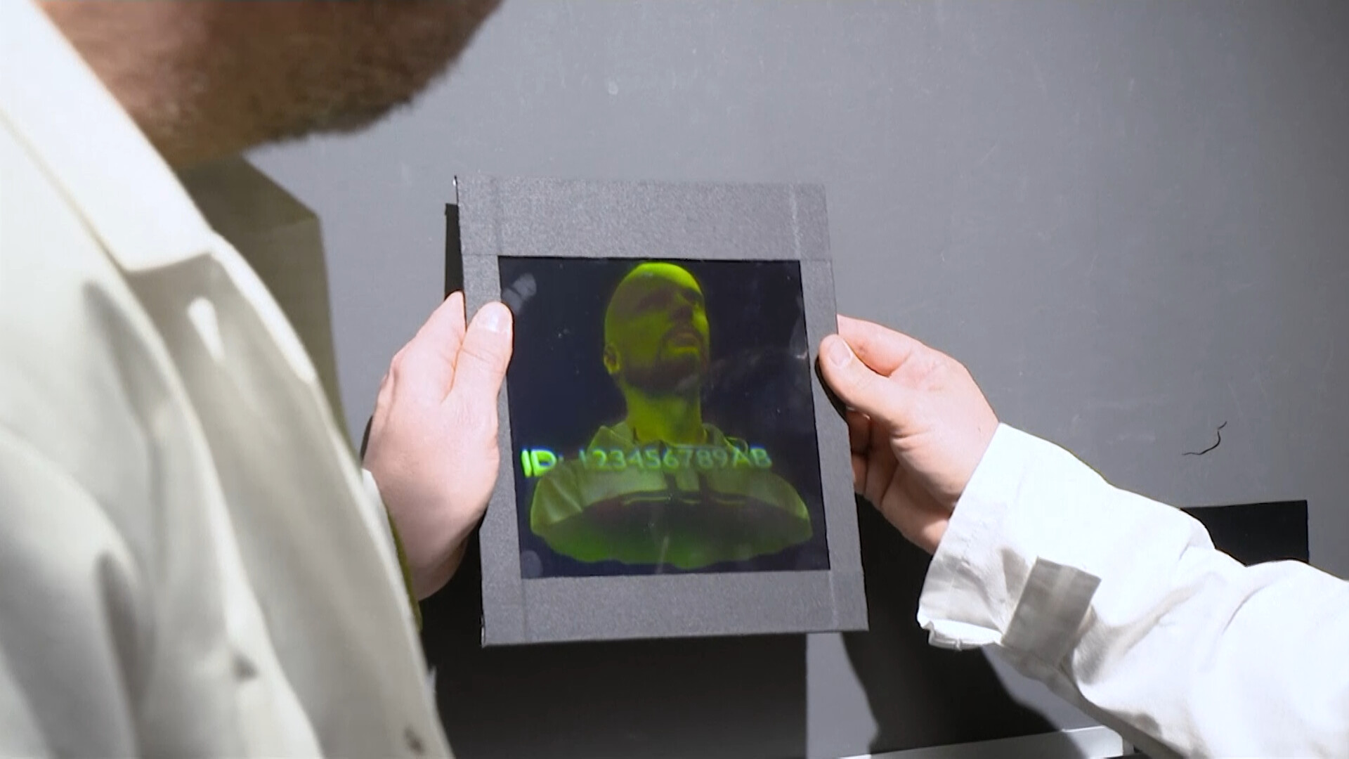 Researchers holding a holographic image