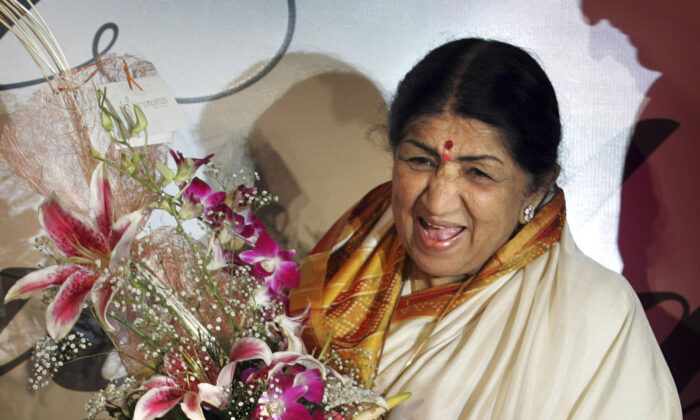 Singer Lata Mangeshkar laughs at the launch of her hindi music album 'Saadgi' or Simplicity, on World Music Day, in Mumbai, India, June 21, 2007. (Rajesh Nirgude/AP Photo/file)