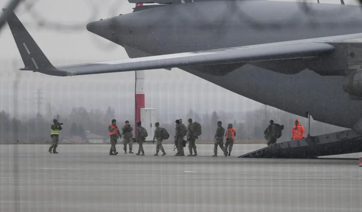U.S. Army troops of the 82nd Airborne Division unloading vehicles from a transport plane after arriving from Fort Bragg, at the Rzeszow-Jasionka airport in southeastern Poland, on Feb. 6, 2022. (Czarek Sokolowski/AP Photo)