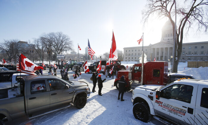 People rally against provincial and federal COVID-19 vaccine mandates and in support of Ottawa protesters, outside the Manitoba Legislature in Winnipeg on Feb. 4, 2022. (The Canadian Press/John Woods)