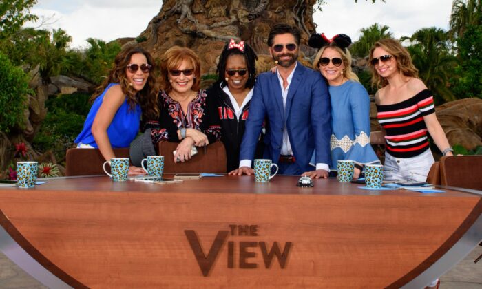(L-R) In this handout photo provided by Disney Resorts, hosts Sunny Hostin, Joy Behar, Whoopi Goldberg, guest John Stamos, Sara Haines and Jedediah Bila pose on ABC's "The View" broadcasting from Disneys Animal Kingdom in Lake Buena Vista, Fla., on March 6, 2017. (Todd Anderson/Disney Resorts via Getty Images)