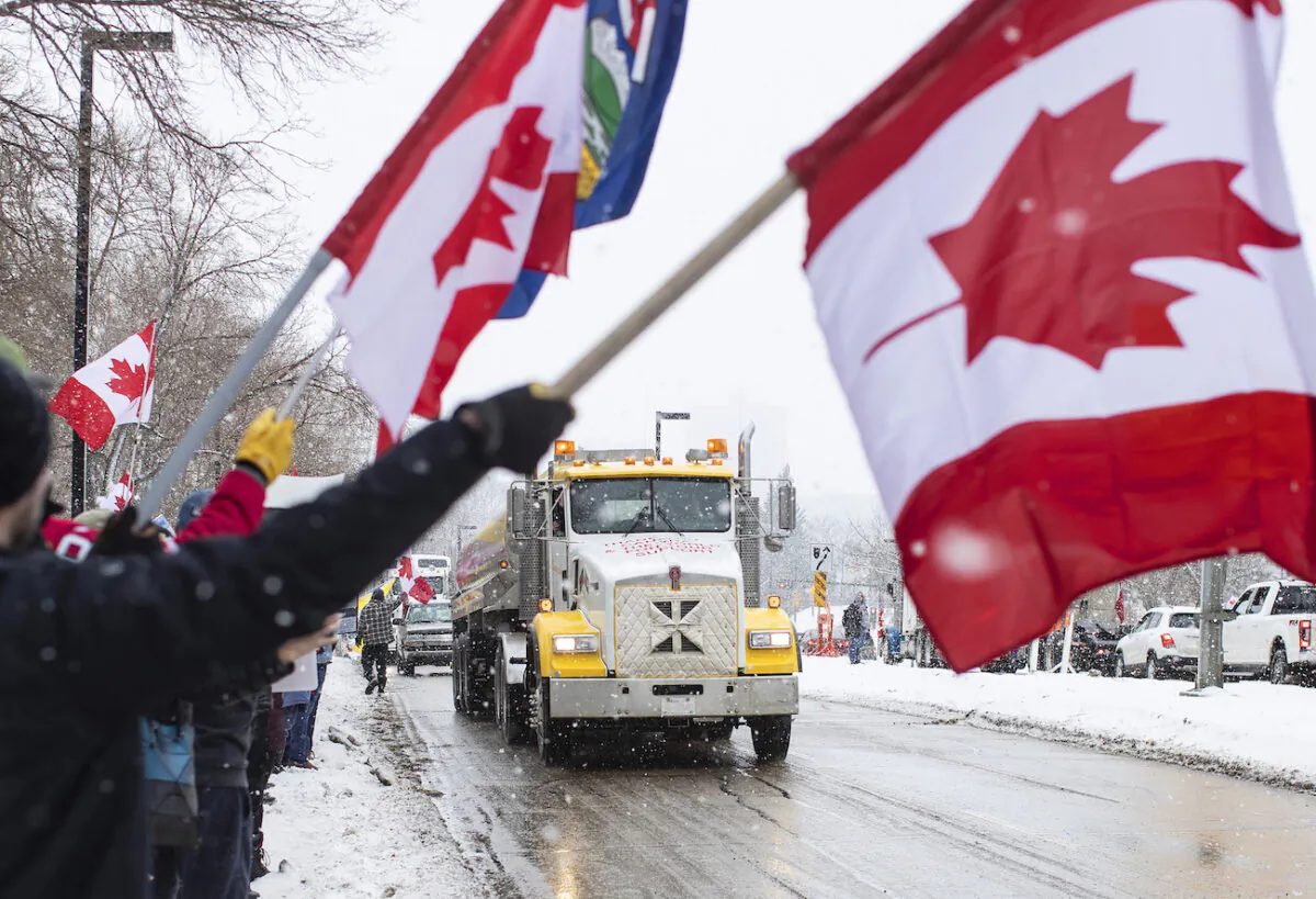 People gather in protest against COVID-19 mandates and in support of a protest against COVID-19 restrictions taking place in Ottawa, in Edmonton, Canada, on Feb. 5, 2022. (Jason Franson/The Canadian Press via AP)