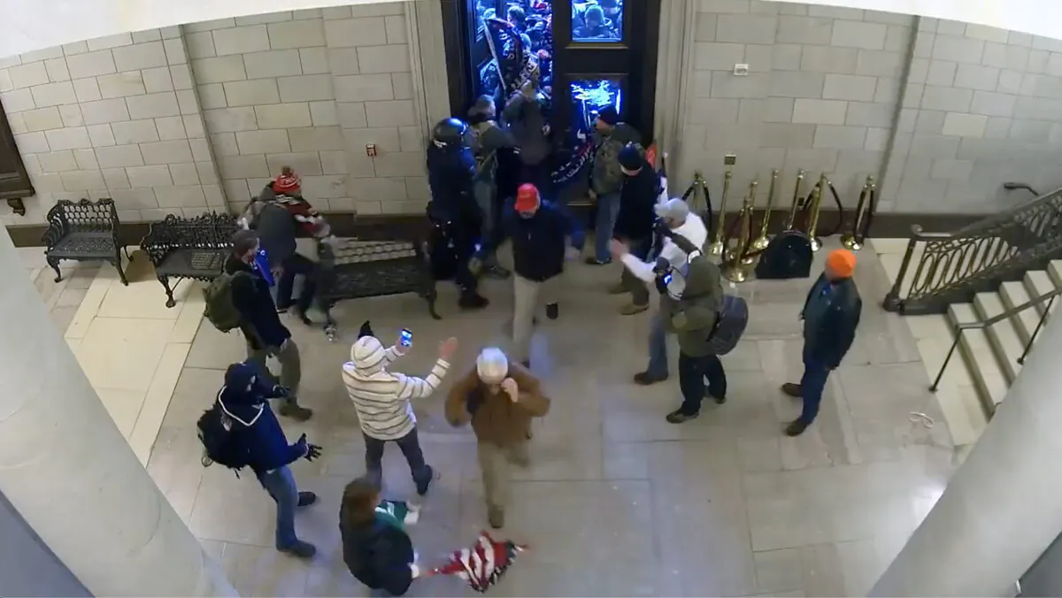 People flow into the Capitol Rotunda after being let in by a protester, shown on this surveillance video on Jan. 6, 2021. (U.S. Department of Justice/Screenshot via The Epoch Times)