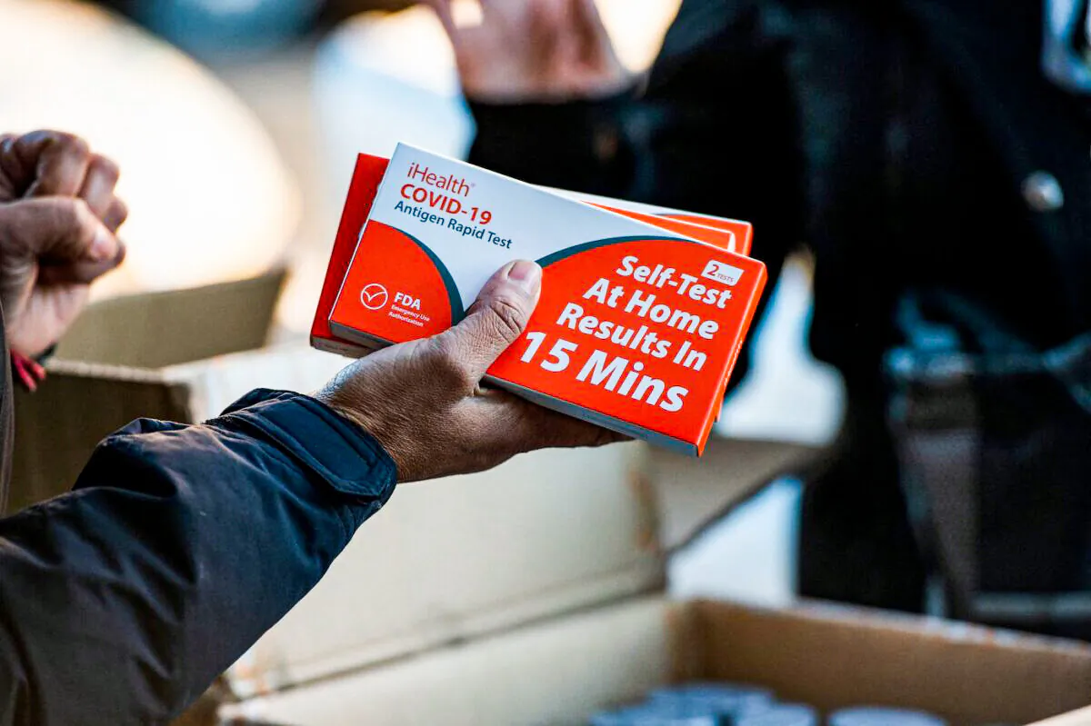 Rapid at-home COVID-19 test kits are distributed in Chelsea, Mass., on Dec. 17, 2021. (Joseph Prezioso/AFP via Getty Images)