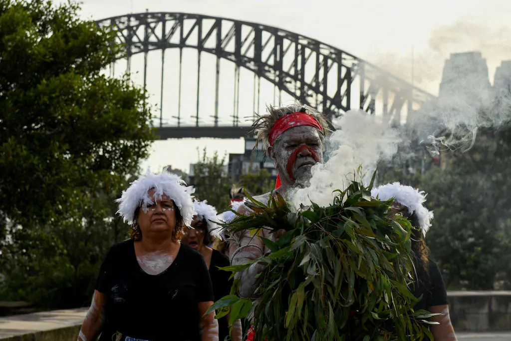 Koomurri-Bujja Bujja dancers arrive for the smoking ceremony during the WugulOra Morning Ceremony as part of Australia Day 2022 celebrations at Walumil Lawns in Sydney, Australia, on Jan. 26, 2022. (Bianca De Marchi - Pool/Getty Images)