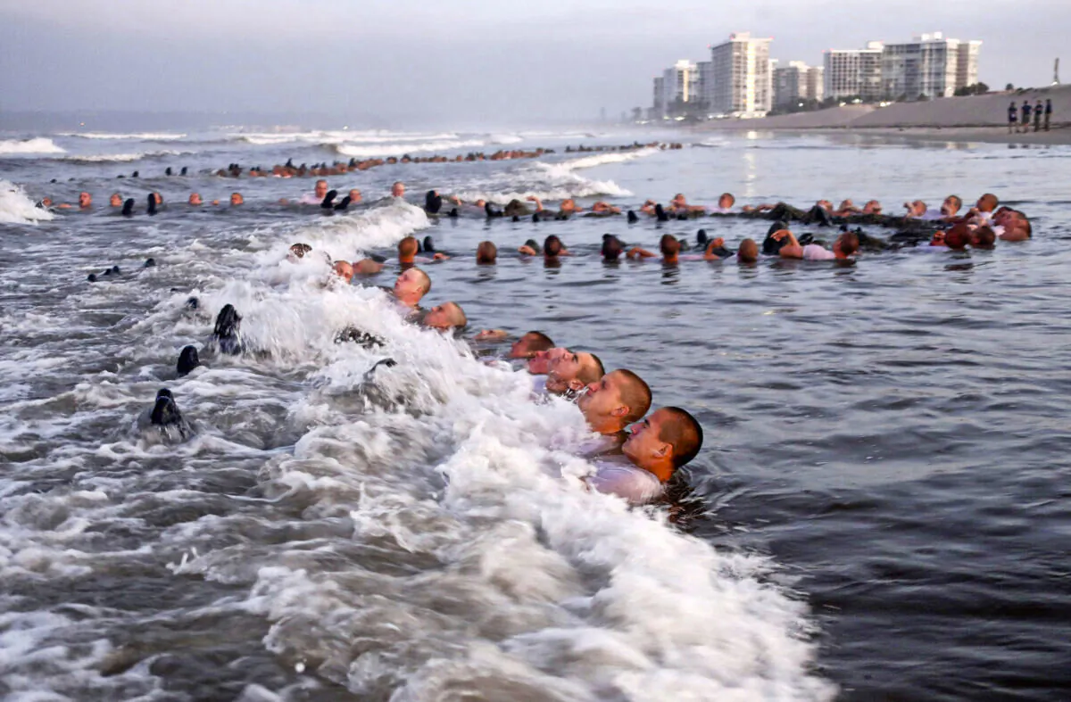 U.S. Navy SEAL candidates participate in "surf immersion" during Basic Underwater Demolition/SEAL (BUD/S) training at the Naval Special Warfare (NSW) Center in Coronado, Calif., on May 4, 2020. (MC1 Anthony Walker/U.S. Navy via AP)