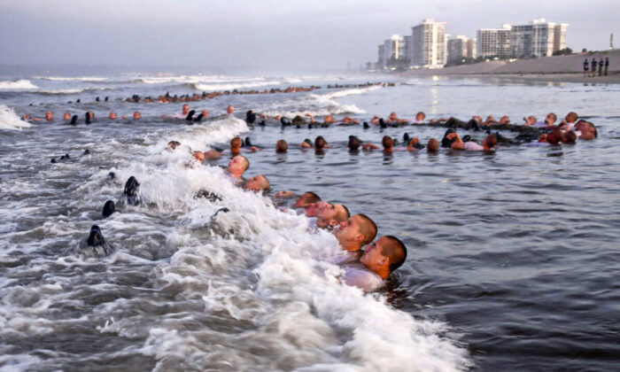 U.S. Navy SEAL candidates participate in "surf immersion" during Basic Underwater Demolition/SEAL (BUD/S) training at the Naval Special Warfare (NSW) Center in Coronado, Calif., on May 4, 2020. (MC1 Anthony Walker/U.S. Navy via AP)