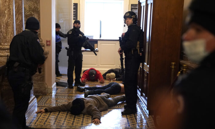 U.S. Capitol Police detain protesters outside of the House Chamber on Jan. 6, 2021. (Drew Angerer/Getty Images)