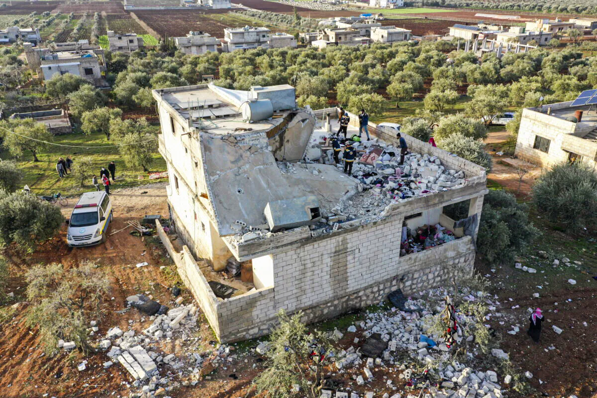 People inspect a destroyed house following an operation by the U.S. military in the Syrian village of Atmeh, in Idlib province, Syria, Thursday, Feb. 3, 2022. U.S. special operations forces conducted a large-scale counterterrorism raid in northwestern Syria overnight Thursday, in what the Pentagon said was a "successful mission." Residents and activists reported multiple deaths including civilians from the attack. (AP Photo/Ghaith Alsayed)