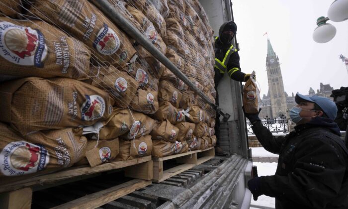 A bag of potatoes from Prince Edward Island will be unloaded from an Ottawa transport truck on December 8, 2021.  (Canadian Press / Adrian Wild)