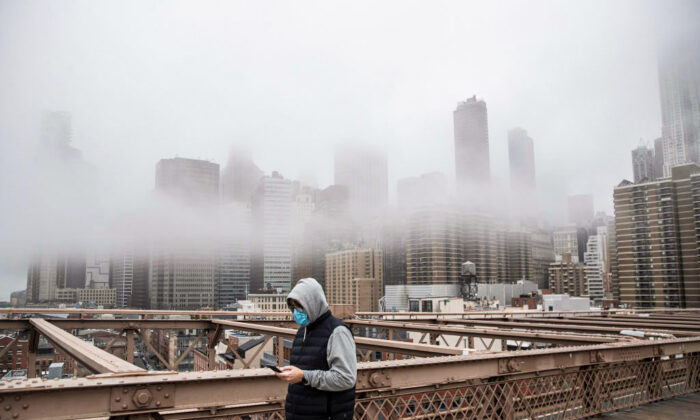 A man wearing a mask walks the Brooklyn Bridge in New York on March 20, 2020. 

Victor J. Blue/Getty Images
