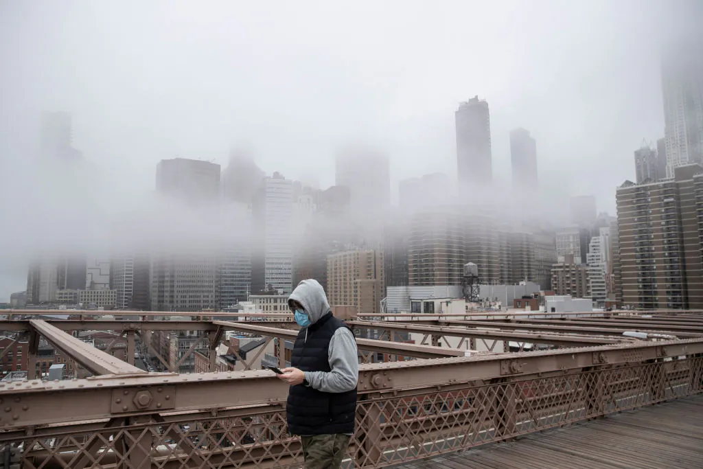 A man wearing a mask walks the Brooklyn Bridge in New York on March 20, 2020. 

Victor J. Blue/Getty Images