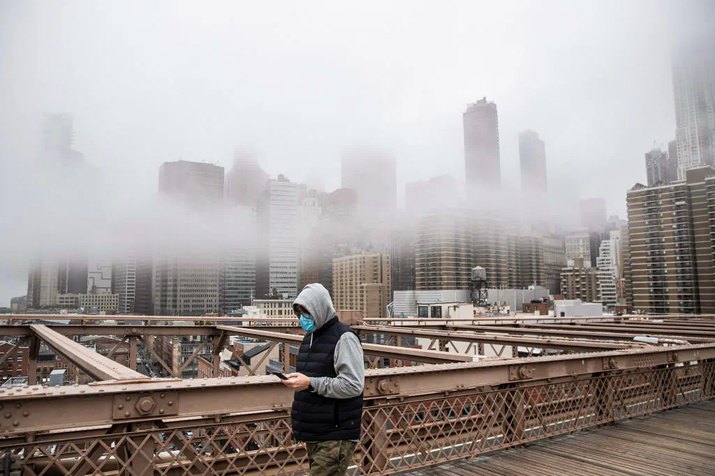 A man wearing a mask walks the Brooklyn Bridge in New York on March 20, 2020.
Victor J. Blue/Getty Images