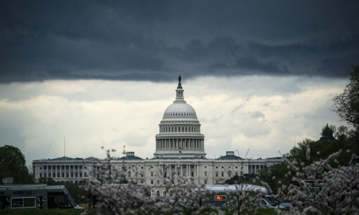 Clouds form above the U.S. Capitol in between rain showers on the National Mall in Washington, on March 28, 2021. (Al Drago/Getty Images)