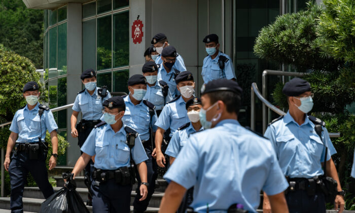 Police carry evidence they sized from the headquarters of the Apple Daily newspaper and its publisher Next Digital Ltd. on June 17, 2021 in Hong Kong, China. (Anthony Kwan/Getty Images)