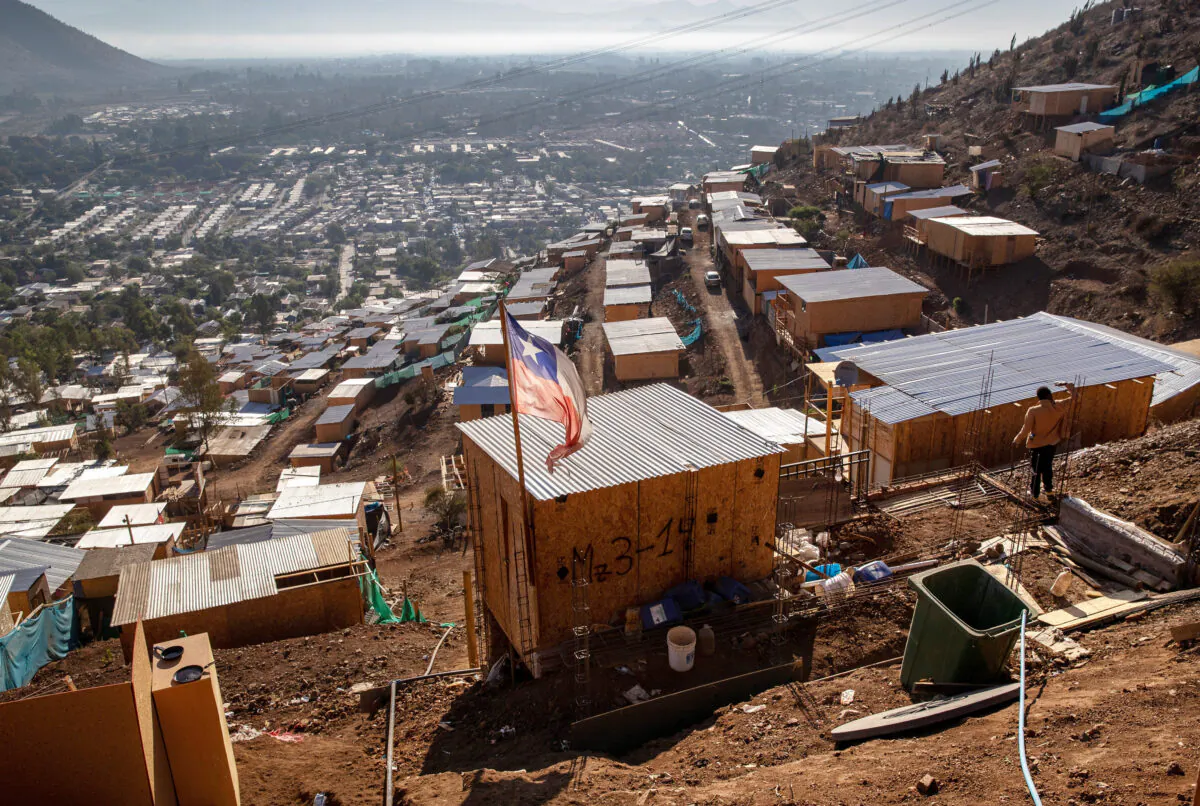 The Chilean flag flies over a mountainside squatter camp built by Haitian and Peruvian immigrants, in Lampa, Chile, on Nov. 21, 2021. (John Moore/Getty Images)