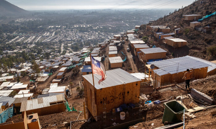 The Chilean flag flies over a mountainside squatter camp built by Haitian and Peruvian immigrants, in Lampa, Chile, on Nov. 21, 2021. (John Moore/Getty Images)