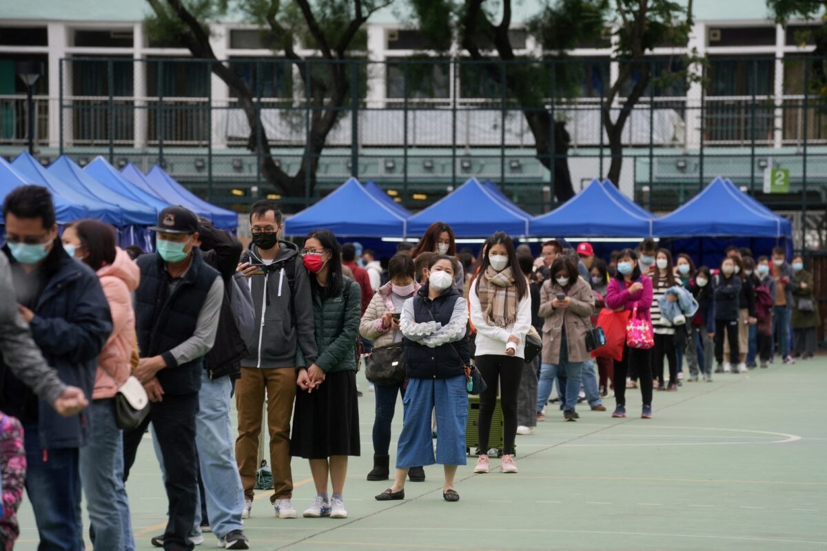 People wearing face masks and queue