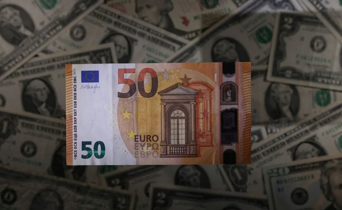 A Euro banknote is seen placed on U.S. Dollar banknotes in this illustration taken on Nov. 28, 2021. (Dado Ruvic/Illustration/Reuters)