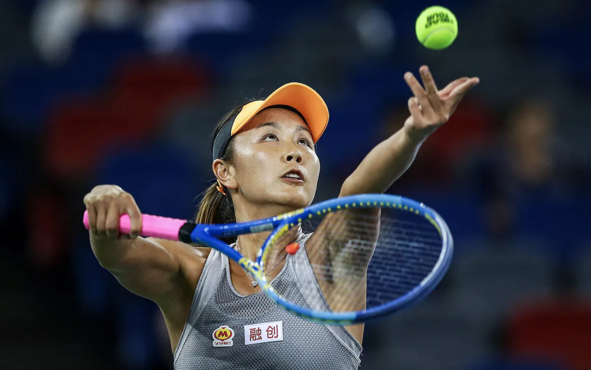Shuai Peng of China severs a shot during the match against Garbine Muguruza of Spain on Day 2 of 2019 Dongfeng Motor Wuhan Open at Optics Valley International Tennis Center in Wuhan, China, on Sept. 23, 2019. (Wang He/Getty Images)