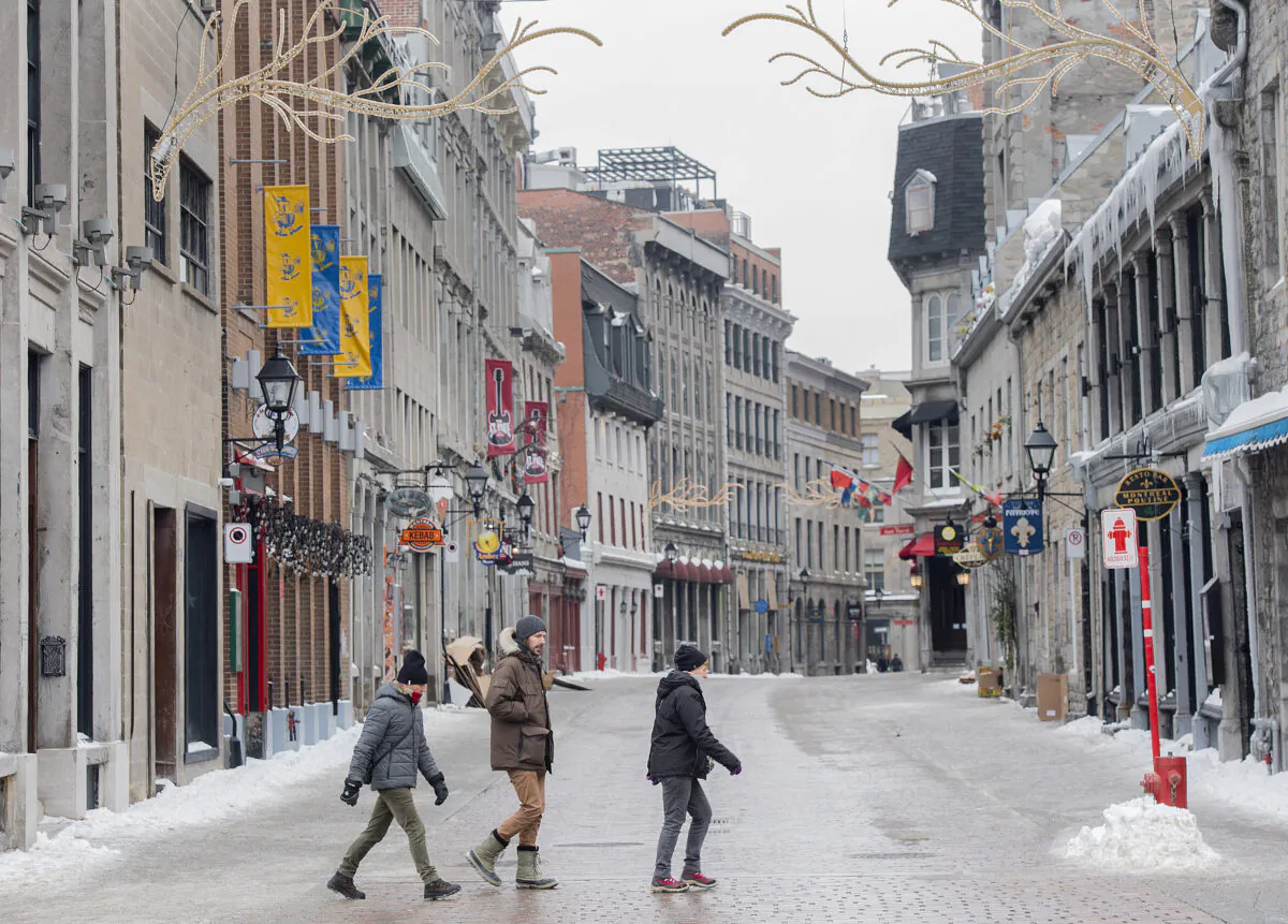 People walk through Old Montreal on Feb. 8, 2022, as the COVID-19 pandemic continues in Canada. (The Canadian Press/Graham Hughes)