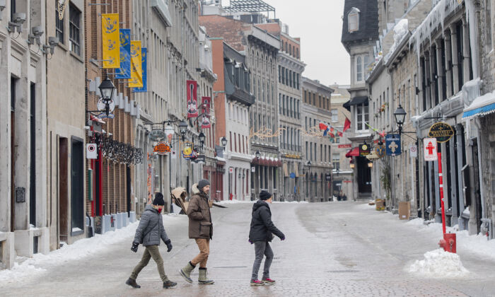 People walk through Old Montreal, Tuesday, Feb. 8, 2022, as the COVID-19 pandemic continues in Canada. (The Canadian Press/Graham Hughes)