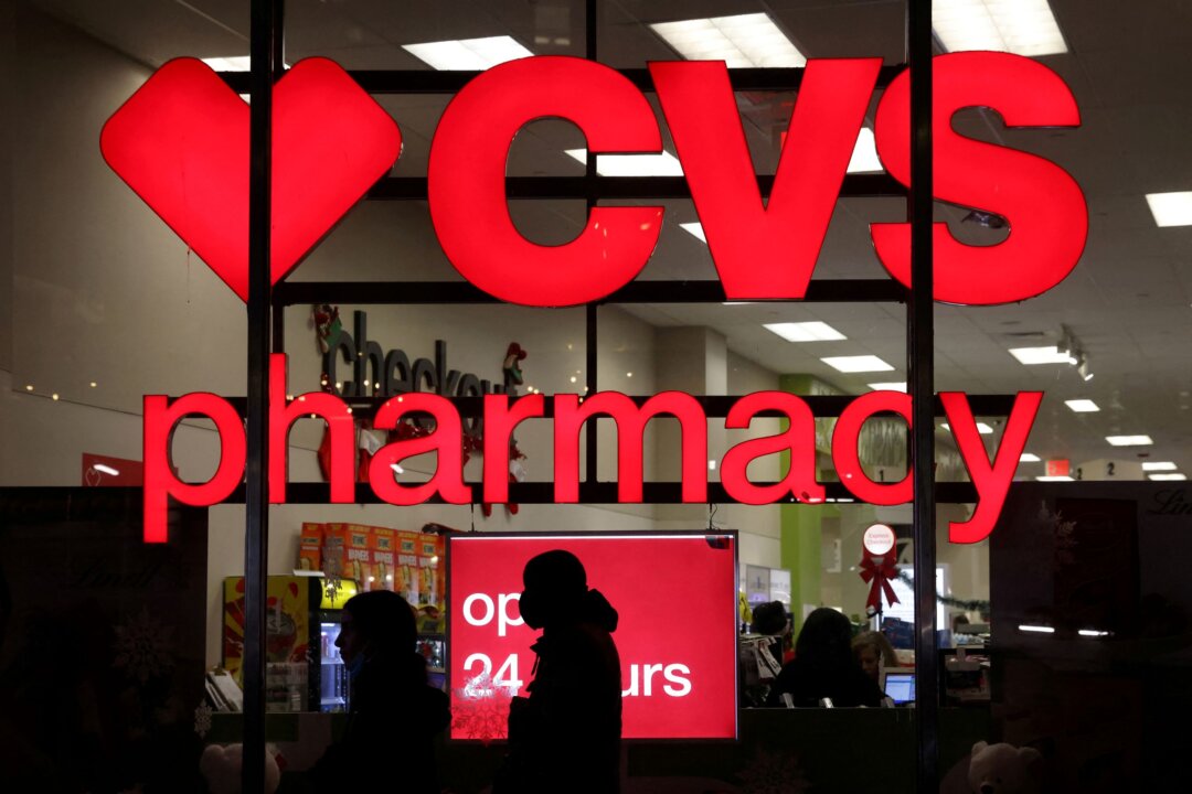 People walk by a CVS pharmacy store in New York on Nov. 17, 2021. (Andrew Kelly/Reuters)