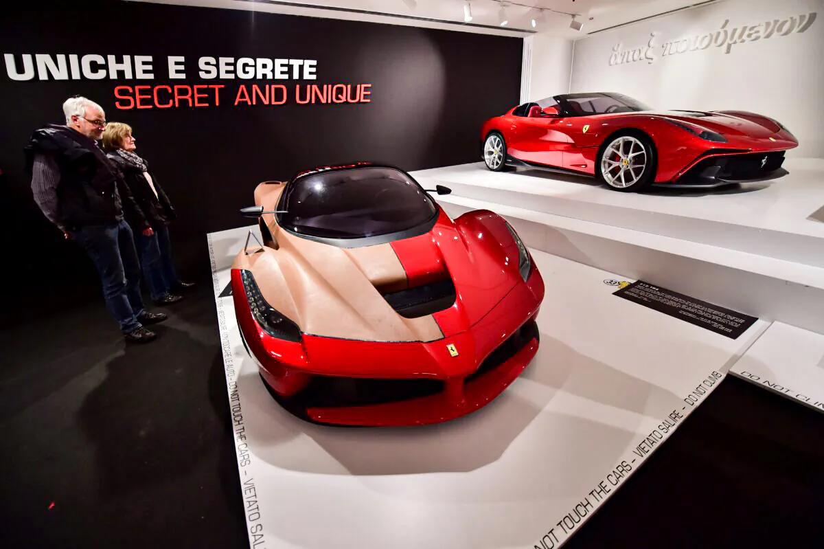 Visitors look at a Ferrari F12 TRS at the Ferrari Museum in Maranello, Italy, on Oct. 18, 2015. (Giuseppe Cacace/AFP via Getty Images)