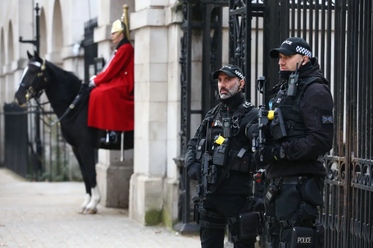 Armed police officers stand guard by a member of the Household cavalry on Whitehall, in London, on Nov. 5, 2020. (Hollie Adams /AFP via Getty Images)