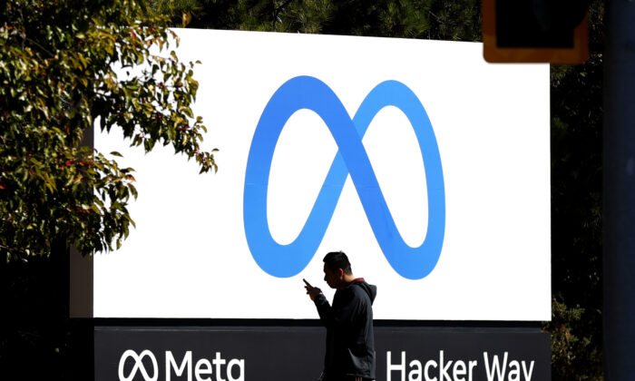 A pedestrian walks in front of the new 'Meta' logo in front of Facebook headquarters in Menlo Park, Calif., on Oct. 28, 2021. (Justin Sullivan/Getty Images)