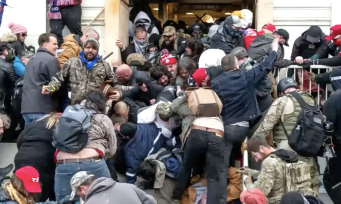 Protesters spill out of the West Terrace tunnel like a waterfall on Jan. 6, 2021. The crowd started to stampede out of the tunnel after police deployed gas on the crowd, witnesses said. (Video Still/Gary McBride)