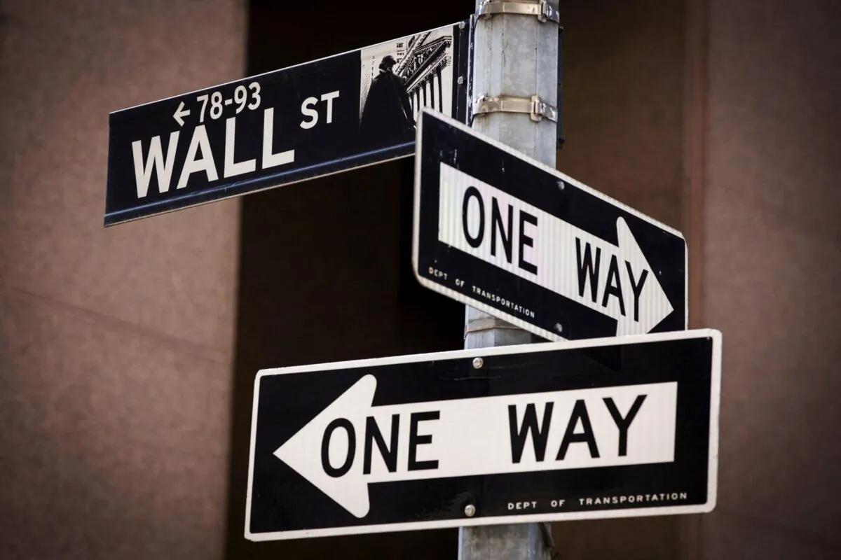 A 'Wall St' sign is seen above two 'One Way' signs in New York, on Aug. 24, 2015. (Lucas Jackson/Reuters)