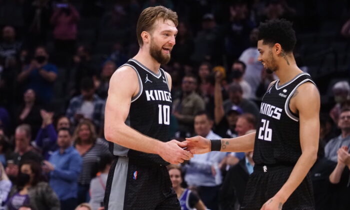 Sacramento Kings center Domantas Sabonis (10) celebrates with guard Jeremy Lamb (26) in the final seconds of the game against the Minnesota Timberwolves during the fourth quarter at Golden 1 Center in Sacramento, Calif., on Feb. 9, 2022. (Kelley L Cox/USA TODAY Sports via Field Level Media)