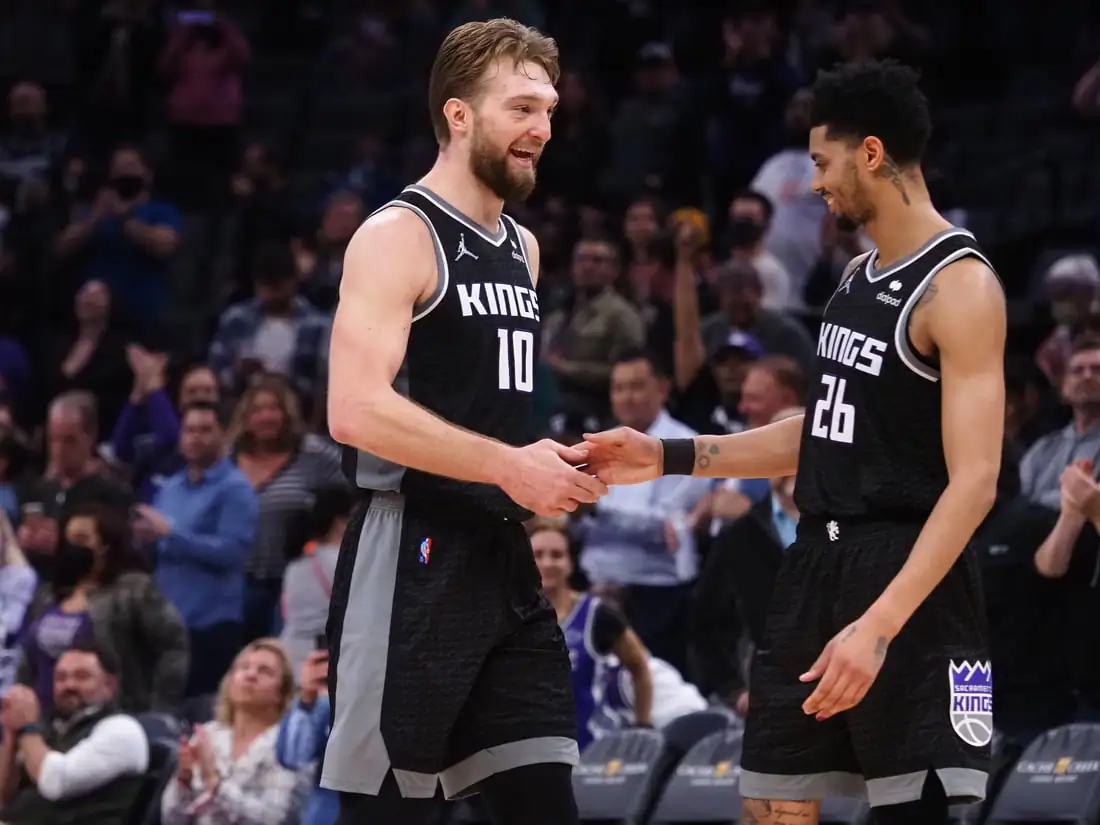 Sacramento Kings center Domantas Sabonis (10) celebrates with guard Jeremy Lamb (26) in the final seconds of the game against the Minnesota Timberwolves during the fourth quarter at Golden 1 Center in Sacramento, Calif., on Feb. 9, 2022. (Kelley L Cox/USA TODAY Sports via Field Level Media)