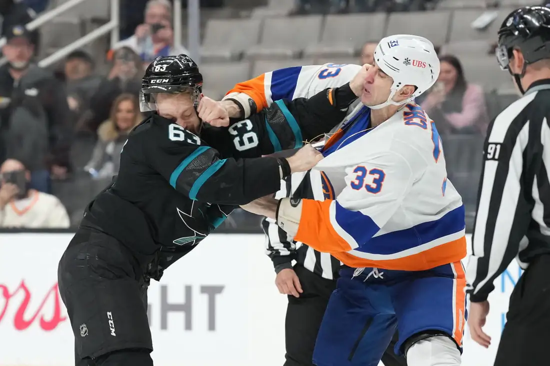 San Jose Sharks left wing Jeffrey Viel (63) and New York Islanders defenseman Zdeno Chara (33) fight during the second period at SAP Center at San Jose, Calif., on Feb 24, 2022. (Darren Yamashita/USA TODAY Sports via Field Level Media)