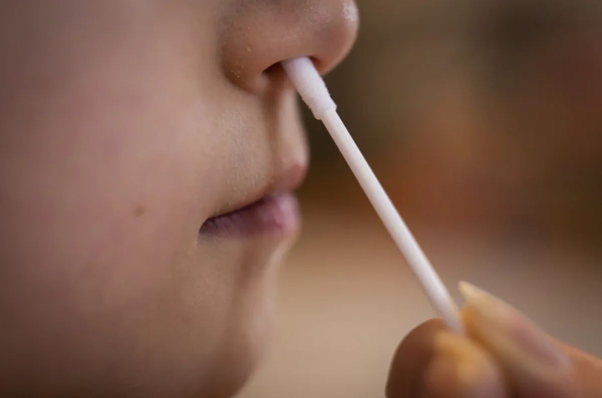 Undated photo A child being given a Covid-19 test (Danny Lawson/PA)
