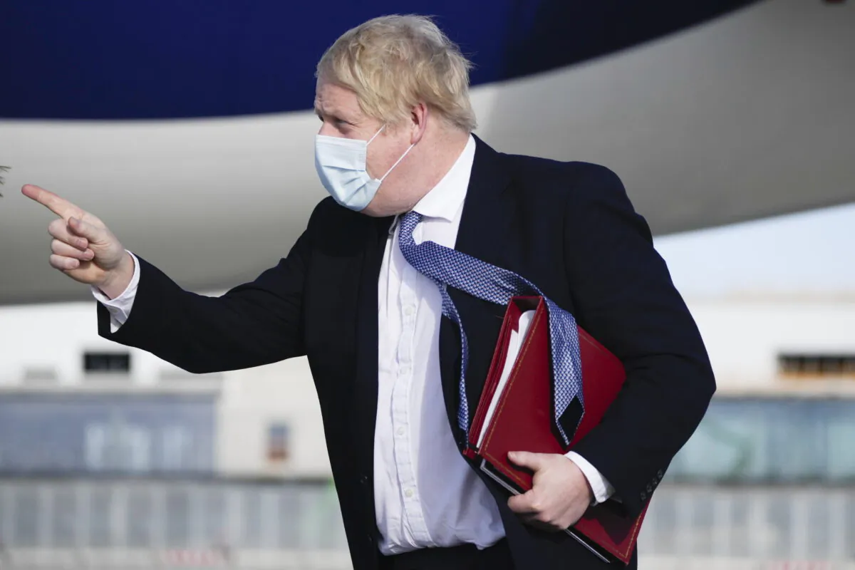 British Prime Minister Boris Johnson arrives on a flight in Munich, Germany, on Feb. 19, 2022. (Matt Dunham/PA)