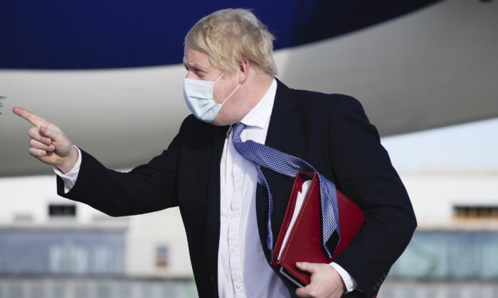 British Prime Minister Boris Johnson arrives on a flight in Munich, Germany, on Feb. 19, 2022. (Matt Dunham/PA)