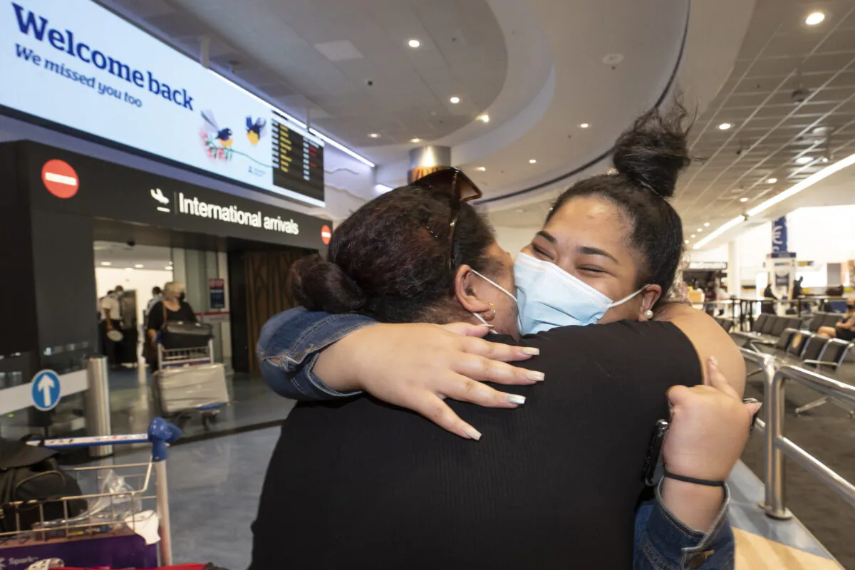 Two women embrace after one arrives at Auckland International Airport in Auckland, New Zealand on Feb. 26, 2022. (Brett Phibbs/New Zealand Herald via AP)