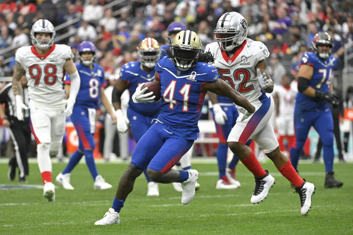 NFC running back Alvin Kamara of the New Orleans Saints (41) rushes as AFC inside linebacker Denzel Perryman of the Las Vegas Raiders (52) closes in during the first half of the Pro Bowl NFL football game in Las Vegas, on Feb. 6, 2022. (David Becker/AP Photo)